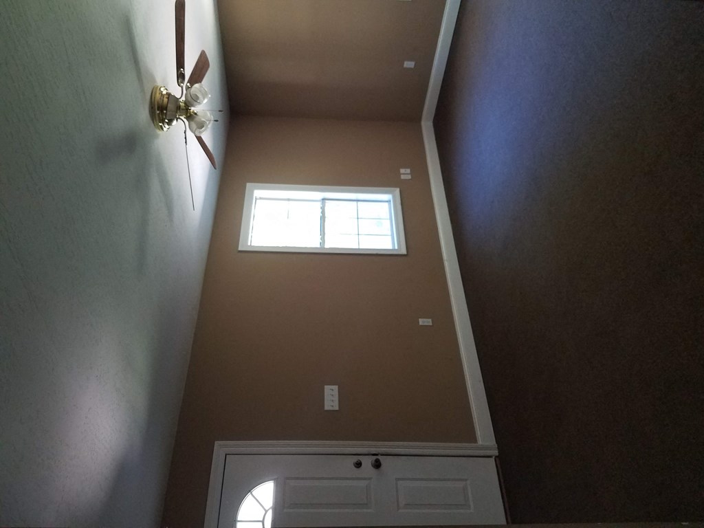 the view from the top of a staircase looking up at a window and a closet
