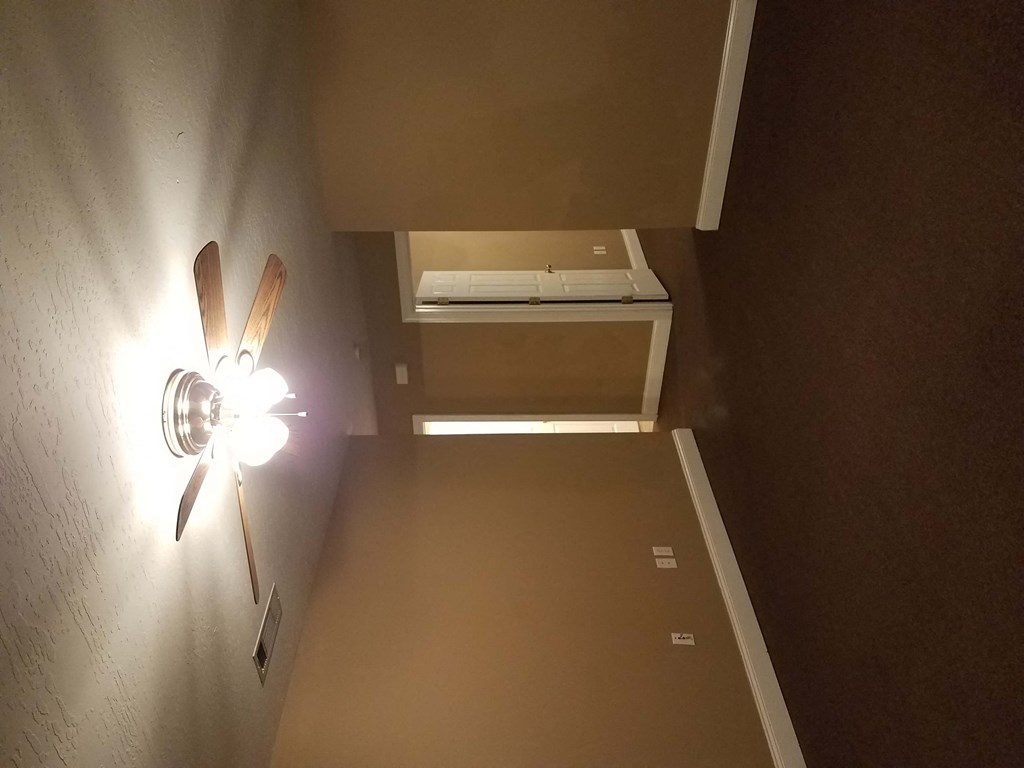 a room with a fan and a printer on a wall