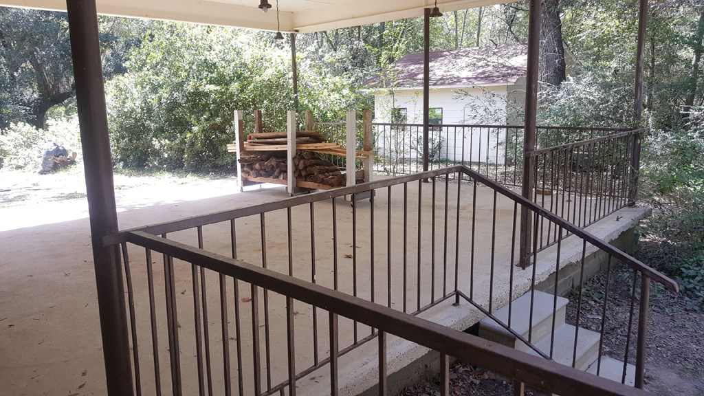 a view of a porch with stairs and a deck