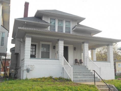 a white house with a porch and stairs