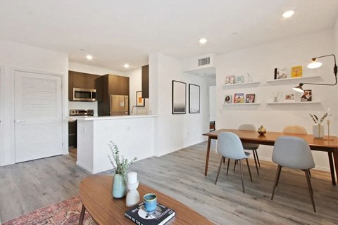 a kitchen and dining room with a table and chairs