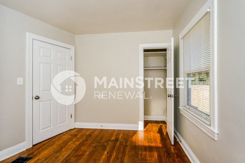 a bedroom with a closet and a white door
