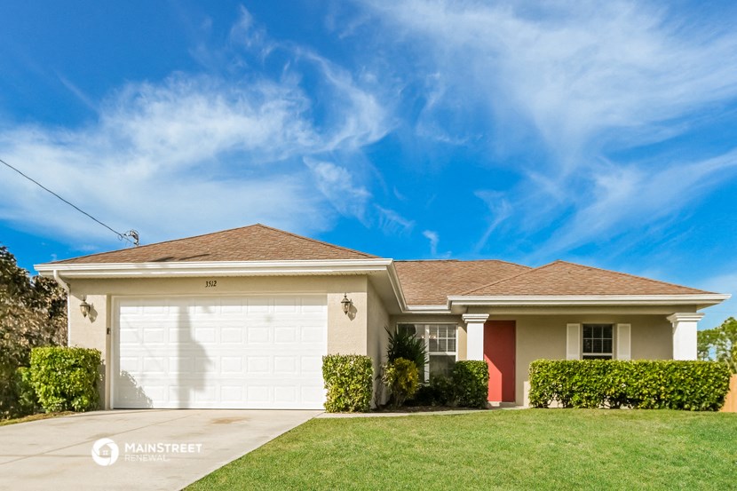 a house with a garage door and a lawn