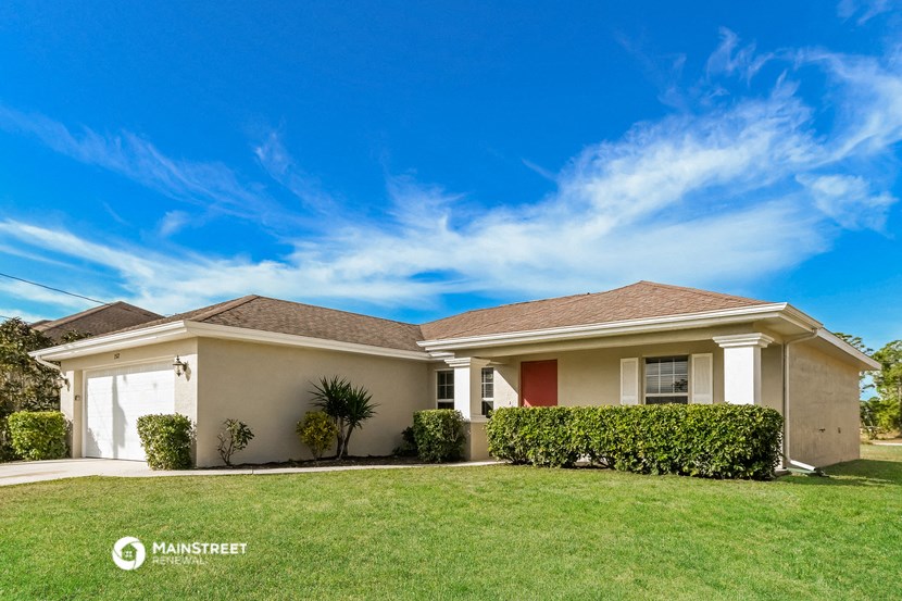 a house with a lawn and a blue sky
