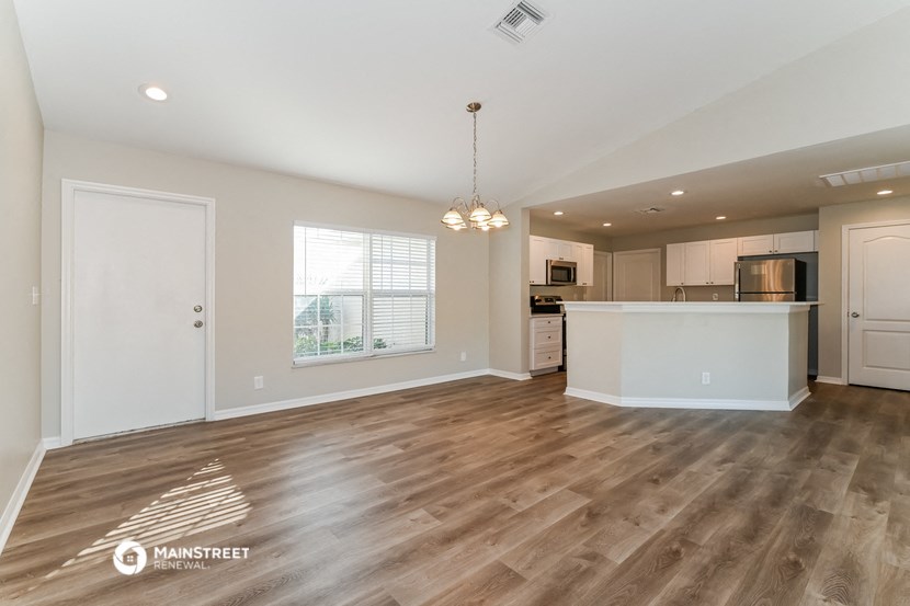 the kitchen and living room of a new home