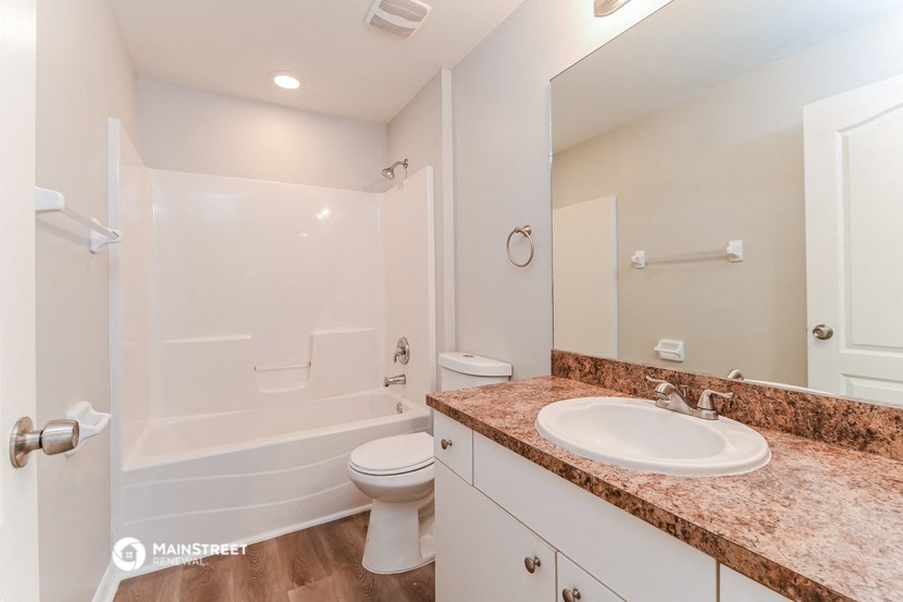 a bathroom with a sink and a shower and a toilet
