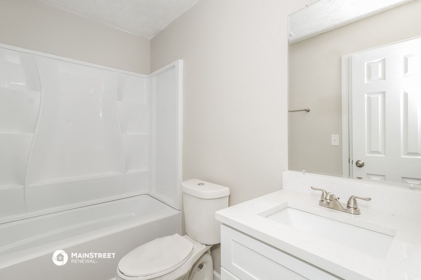 a bathroom with a sink toilet and a bath tub