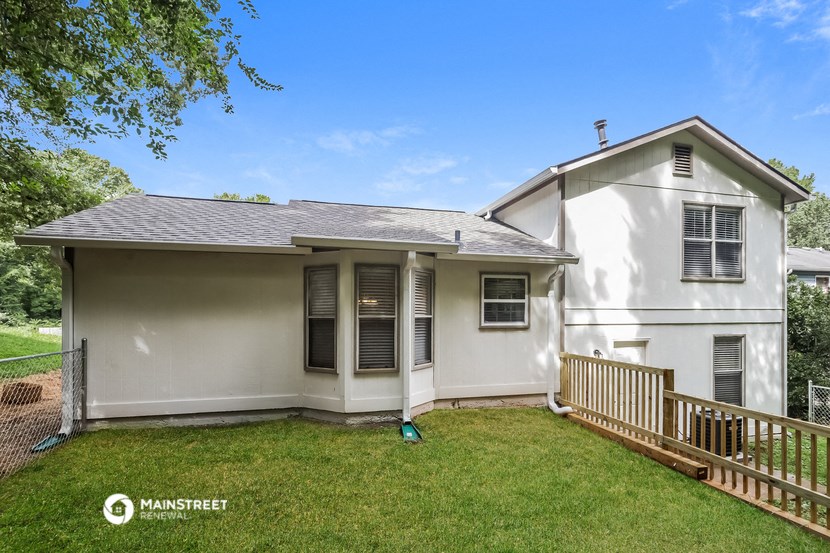 a white house with a yard and a deck