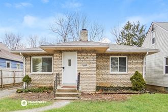 a small brick house with a white door