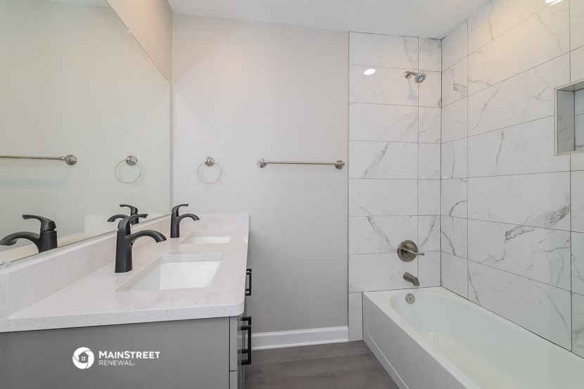 a bathroom with a sink and a tub and a shower