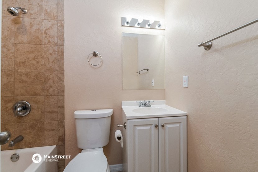 a bathroom with a sink toilet and a mirror