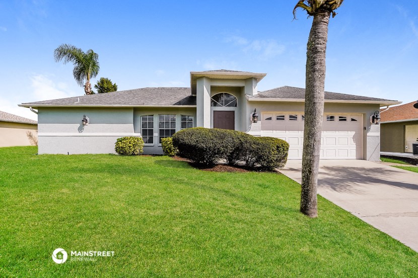 a house with a garage and a palm tree