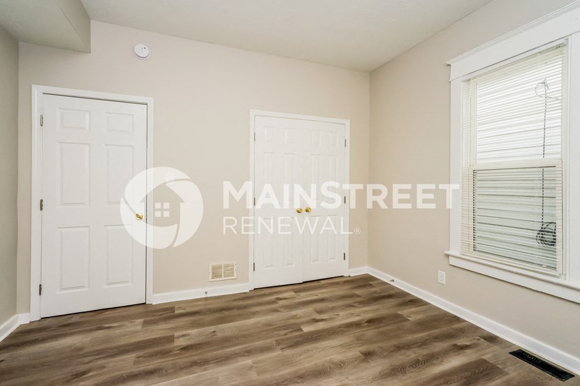 a bedroom with two closets and a white door