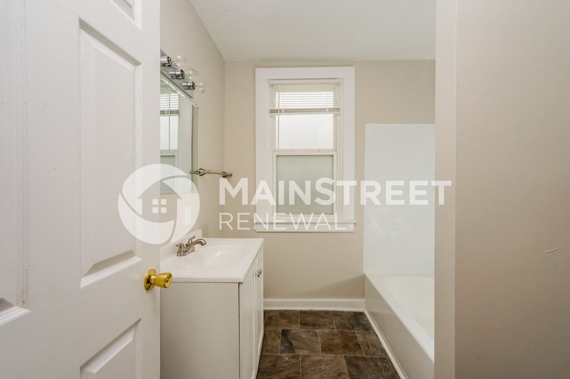 a renovated bathroom with a sink and a shower
