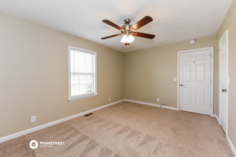 the master bedroom is spacious and has a ceiling fan