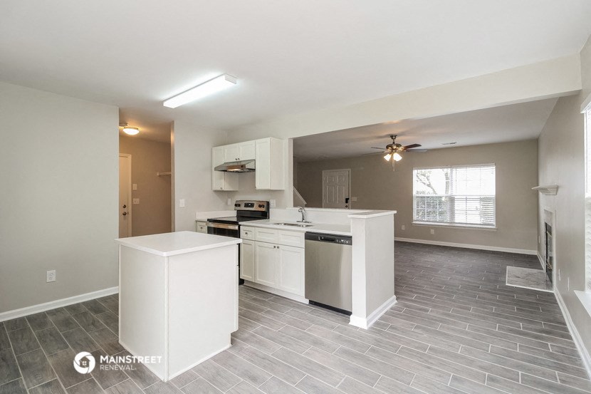 a kitchen with white cabinets and a white counter top