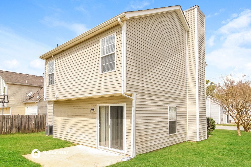 a renovated house with a garage and a yard