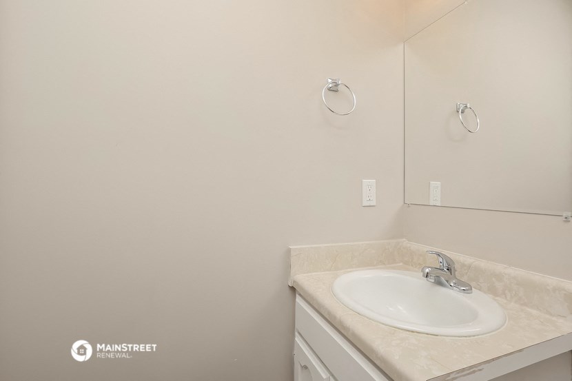a white bathroom with a sink and a mirror