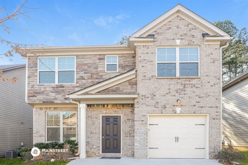 a brick house with a white garage door