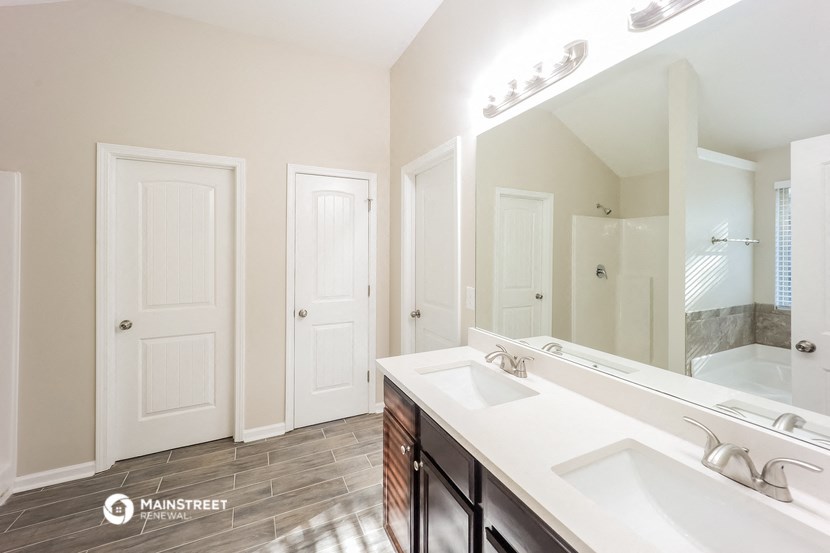 a bathroom with two sinks and a large mirror