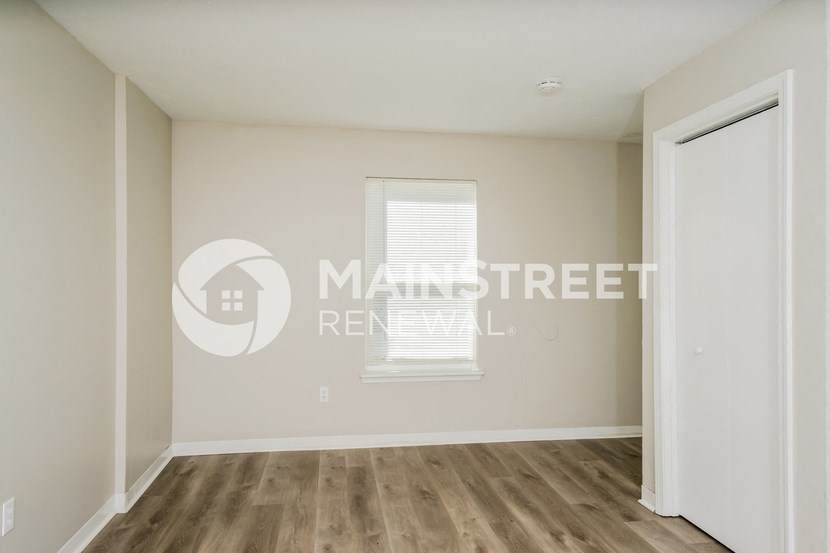 a bedroom apartment with a closet and a window