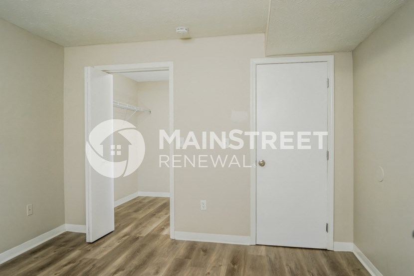 a bedroom with a closet and a closet door