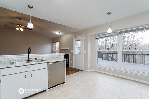 a kitchen with a large window and a sink and a counter top