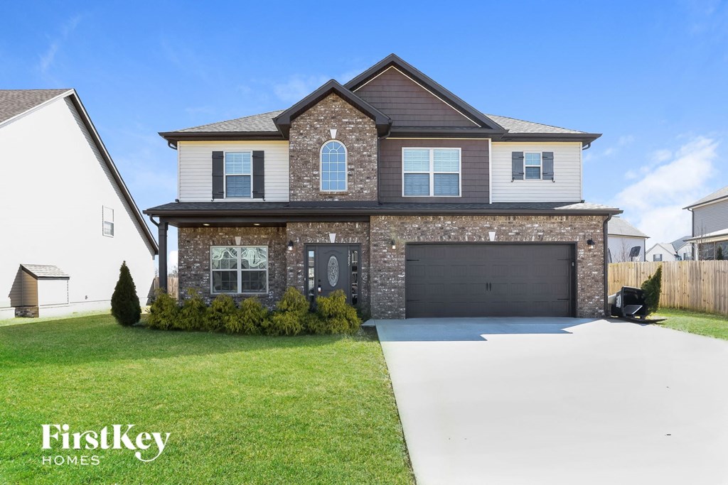 a large house with a garage and a driveway
