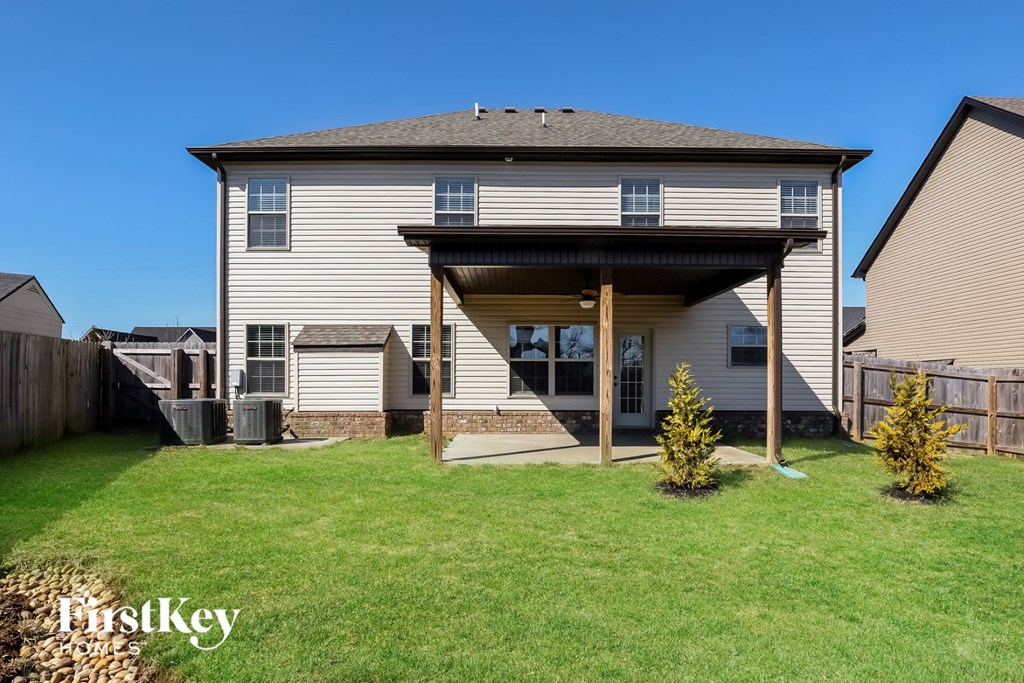 a backyard with a house with a covered patio