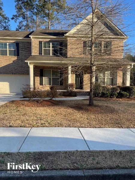 a brick house with a sidewalk in front of it