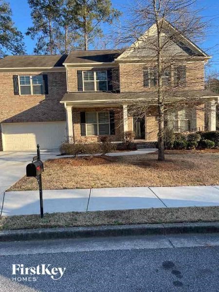 a brick house with a parking meter on the sidewalk