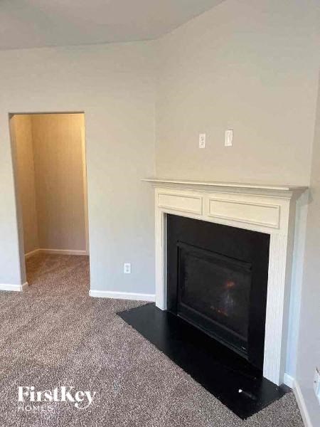 an empty living room with a fireplace