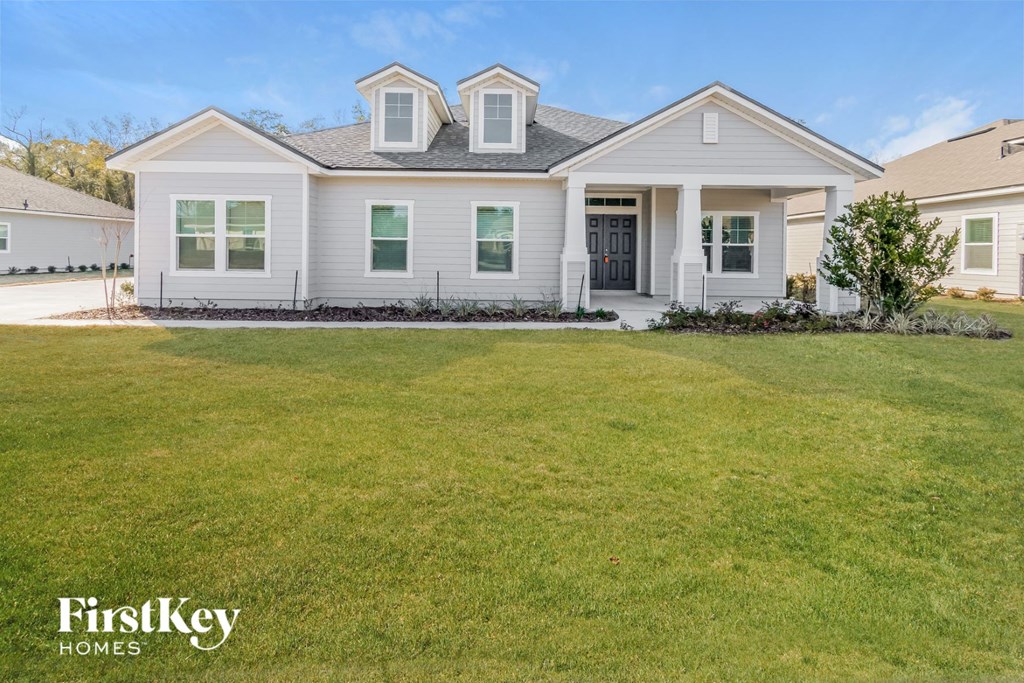 A house with a lawn in front of it.