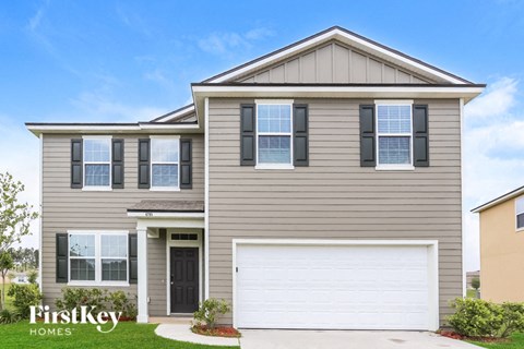A two-story house with a garage is for sale by FirstKey Homes.