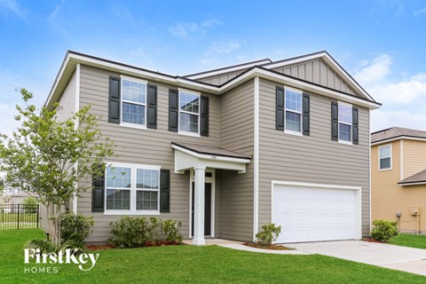 A house with a garage door is for sale by FirstKey Homes.