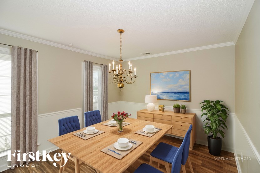 A dining room with a wooden table set for two.