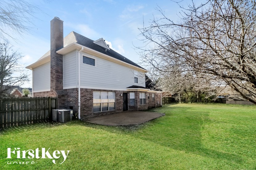A house with a white exterior and a chimney is for sale by FirstKey.