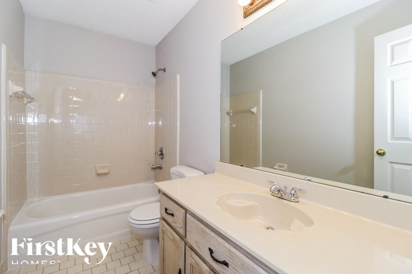 a bathroom with a sink and a toilet and a shower