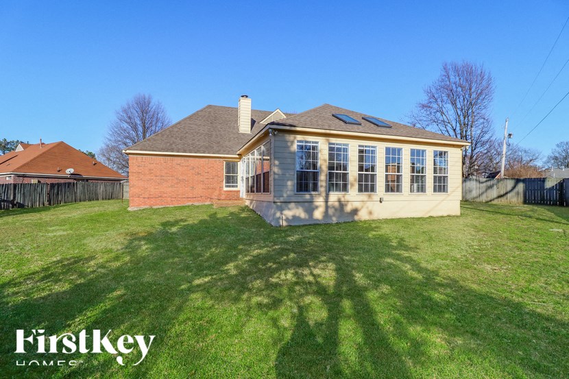 the back of a house with a yard and a garage