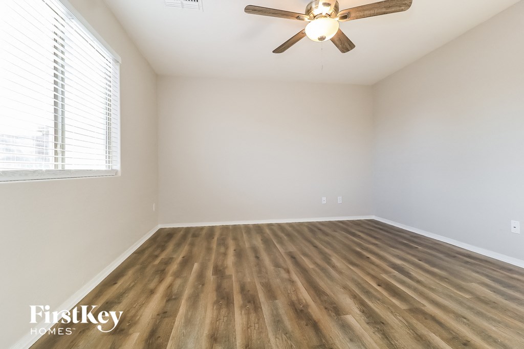 a living room with hardwood floors and a ceiling fan
