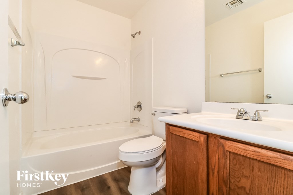 a bathroom with a sink toilet and a tub