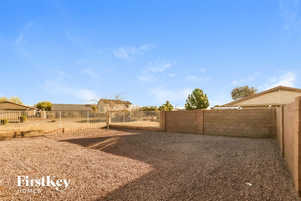 a fenced in yard with a fence and a house