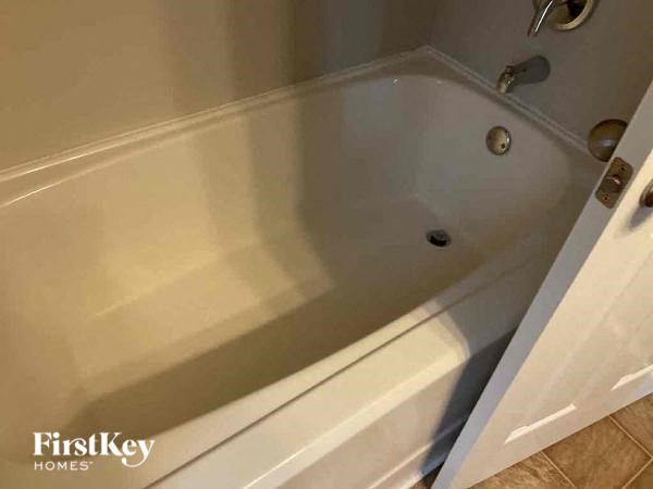 a bath tub in a bathroom with the door open