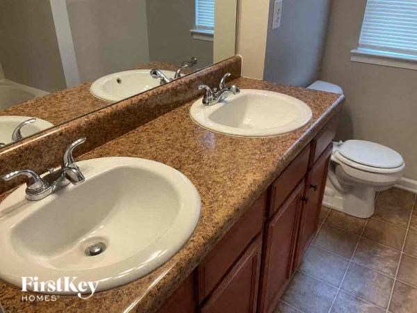 a bathroom with two sinks and a toilet