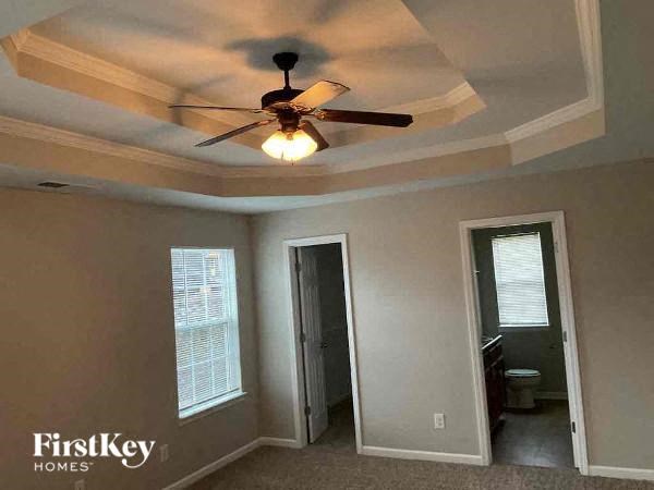 a bedroom with a ceiling fan and a door