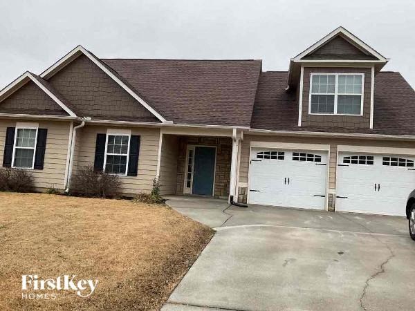 a house with a driveway and two garage doors