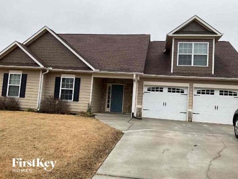 a house with a driveway and two garage doors