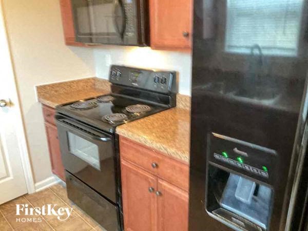 a kitchen with a stove and a refrigerator