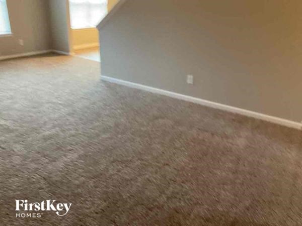 a living room with a carpeted floor
