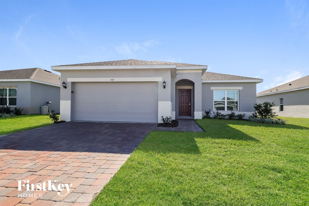 A house with a garage door that says "Firstkey Homes".